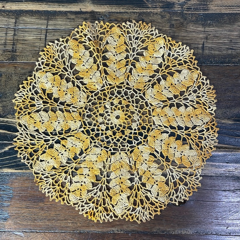 Beautifully hand crafted orange and cream crocheted doily.  Vintage